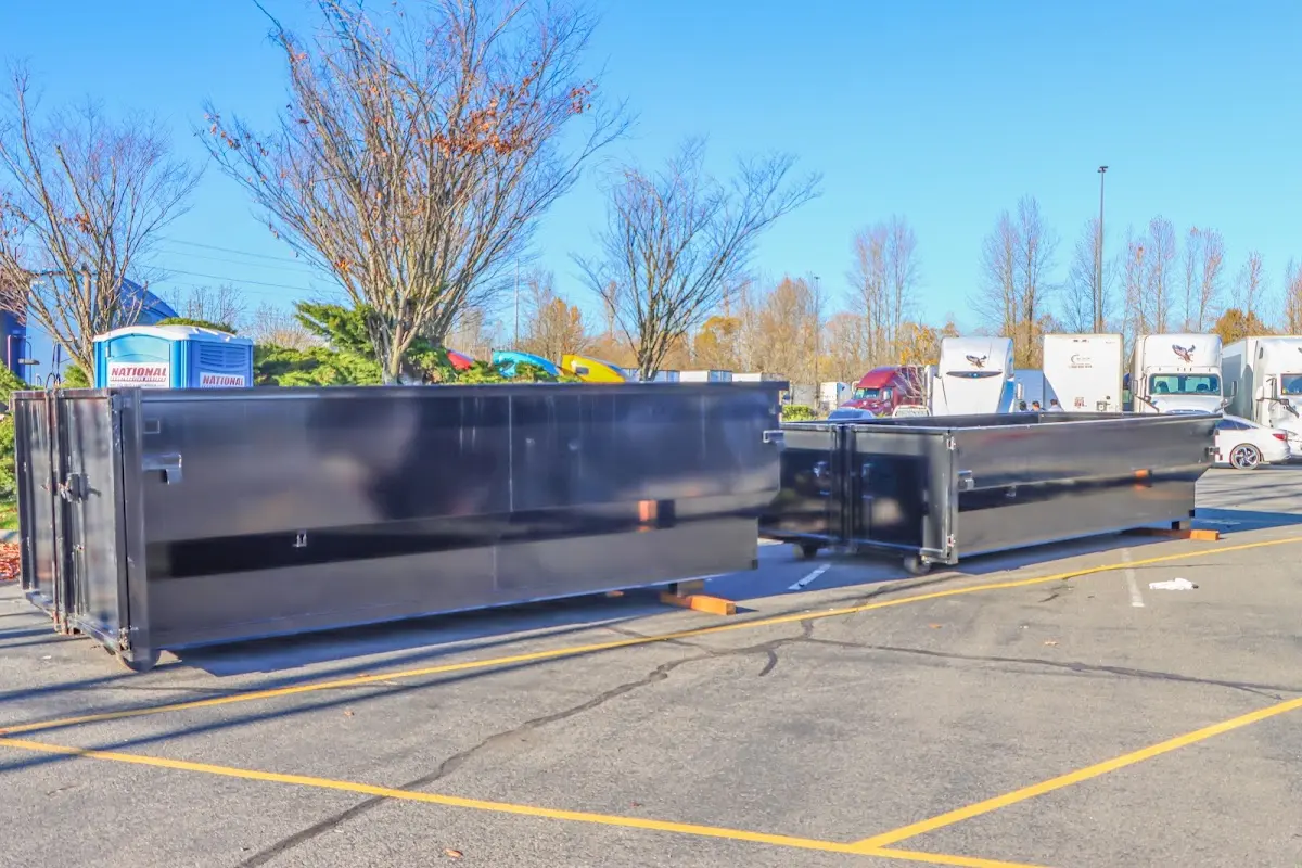 Professional dumpster rental service with roll-off container on residential driveway in Moody